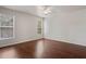 Spacious bedroom featuring hardwood floors and natural lighting from the windows at 16119 Bridgedale Dr, Lithia, FL 33547