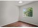 Bedroom featuring hardwood floors, a ceiling fan, and large window at 16119 Bridgedale Dr, Lithia, FL 33547