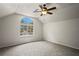 Sunlit bedroom with a large arched window, ceiling fan, and neutral carpeting at 16119 Bridgedale Dr, Lithia, FL 33547
