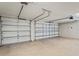 Spacious two car garage with neutral painted walls and ceiling and smooth concrete floors at 16119 Bridgedale Dr, Lithia, FL 33547