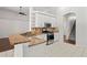 Kitchen featuring granite counters, stainless steel appliances, white cabinets and tile flooring at 16119 Bridgedale Dr, Lithia, FL 33547