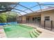Sparkling screened-in pool with patio and steps leading into the water at 16119 Bridgedale Dr, Lithia, FL 33547