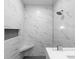 Sleek walk-in shower featuring marble tiling, glass enclosure, built-in niche and a bench at 16431 Penn State Rd, Weeki Wachee, FL 34614