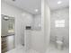 Marble shower with glass door and a peek into the rest of the primary bathroom at 16431 Penn State Rd, Weeki Wachee, FL 34614