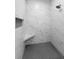 Beautiful bathroom with marble tile in walk-in shower featuring built-in niche and seat at 16431 Penn State Rd, Weeki Wachee, FL 34614