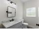 This bathroom offers a marbled vanity, decorative tile floors, and a black framed mirror at 16431 Penn State Rd, Weeki Wachee, FL 34614
