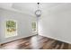 Bright bedroom with hardwood floors, neutral walls, and double windows at 16431 Penn State Rd, Weeki Wachee, FL 34614