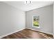 Minimalist bedroom with laminate floors and a single window offering natural light at 16431 Penn State Rd, Weeki Wachee, FL 34614