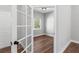 Bedroom with hardwood floors seen through glass doors and a view of the outdoor foliage at 16431 Penn State Rd, Weeki Wachee, FL 34614