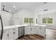 Open kitchen features white cabinets, stainless steel appliances, and ample counter space for cooking at 16431 Penn State Rd, Weeki Wachee, FL 34614