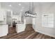 Well-lit kitchen with white cabinetry, stainless steel appliances, and modern fixtures at 16431 Penn State Rd, Weeki Wachee, FL 34614