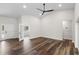 Bright living room with hardwood floors, neutral walls, and vaulted ceiling with fan at 16431 Penn State Rd, Weeki Wachee, FL 34614