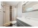 Tiled bathroom featuring modern vanity, mirror, and tiled walk-in shower with decorative accents at 1720 W Arch St, Tampa, FL 33607