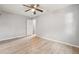 Bedroom with wood-style floors, a ceiling fan, window, and a doorway to the hallway at 1720 W Arch St, Tampa, FL 33607