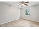 The bedroom includes a ceiling fan, wood-style floors, and a window providing natural light at 1720 W Arch St, Tampa, FL 33607