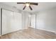 The bedroom has a ceiling fan, wood-style floors, a window, and a sliding closet at 1720 W Arch St, Tampa, FL 33607