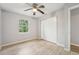 This bedroom has a window, wood-style floors, a ceiling fan, and a sliding closet at 1720 W Arch St, Tampa, FL 33607