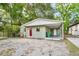 Inviting single-story home with a carport, newly painted exterior, and bright red door at 1720 W Arch St, Tampa, FL 33607