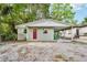 Charming single-story home with a carport, fresh paint, and a vibrant red door at 1720 W Arch St, Tampa, FL 33607