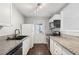 Modern kitchen with white cabinets, granite countertops, stainless steel appliances, and wood flooring at 1720 W Arch St, Tampa, FL 33607