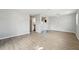 Large living area with light gray walls and flooring, plus an open view into the kitchen at 1720 W Arch St, Tampa, FL 33607