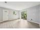 Bright living room with modern flooring, neutral walls, and a sliding glass door at 1720 W Arch St, Tampa, FL 33607