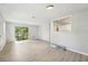 Spacious living room with light gray walls, new flooring, and view to kitchen with modern cabinets at 1720 W Arch St, Tampa, FL 33607