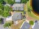 An aerial view of the backyard, trampoline, playset, pond, and partial fencing at 19112 Cypress Green Dr, Lutz, FL 33558