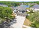 Aerial view of a large two-story home with a spacious driveway and landscaping near a pond at 19112 Cypress Green Dr, Lutz, FL 33558