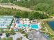 An aerial view features a stunning community swimming pool, a playground and tennis courts by a golf course and lake at 19112 Cypress Green Dr, Lutz, FL 33558