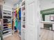 Walk-in closet with ample shelving and storage space, leading to the bathroom at 19112 Cypress Green Dr, Lutz, FL 33558