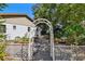Picturesque backyard with a white arbor leading to raised garden beds at 201 Gornto Lake Rd, Brandon, FL 33510