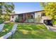 Large backyard featuring lush lawn, landscaping and direct access to covered patio area for relaxing and entertaining at 201 Gornto Lake Rd, Brandon, FL 33510