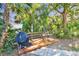Relaxing backyard with grill, wooden deck, dining table, and lush landscaping provides a peaceful outdoor experience at 201 Gornto Lake Rd, Brandon, FL 33510