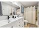 Modern bathroom featuring a double vanity, dark fixtures, white countertops and soft neutral accents at 201 Gornto Lake Rd, Brandon, FL 33510
