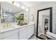 Well-lit bathroom with a double sink vanity, quartz countertops, gold fixtures, and a large framed mirror at 201 Gornto Lake Rd, Brandon, FL 33510