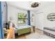 Bright bedroom with stylish wallpaper, modern lighting, and a large window with a pleasant view at 201 Gornto Lake Rd, Brandon, FL 33510