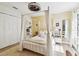 Serene bedroom featuring a four-poster bed with sheer curtains and ample natural light at 201 Gornto Lake Rd, Brandon, FL 33510