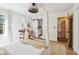 Bedroom featuring a four-poster bed, a desk, and a view into an en-suite bathroom at 201 Gornto Lake Rd, Brandon, FL 33510
