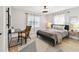 Sunlit bedroom featuring a comfortable bed, stylish patterned rug, a dark teal bed frame, and modern decor at 201 Gornto Lake Rd, Brandon, FL 33510