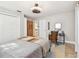 Cozy bedroom featuring a comfortable bed, a desk, and ample natural light from the two windows at 201 Gornto Lake Rd, Brandon, FL 33510