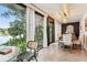 Dining area features floor-to-ceiling windows with waterfront view and modern decor at 201 Gornto Lake Rd, Brandon, FL 33510