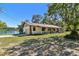 Picturesque exterior view of home with a spacious yard near a tranquil lake at 201 Gornto Lake Rd, Brandon, FL 33510