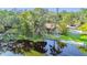 Exterior aerial view of lakefront home featuring mature landscaping and private access to the water at 201 Gornto Lake Rd, Brandon, FL 33510
