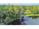 Exterior aerial view of lakefront home featuring mature landscaping, private access to the water and lake views at 201 Gornto Lake Rd, Brandon, FL 33510