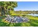 Outdoor fire pit area with chairs, perfect for enjoying serene lake views and relaxing outdoors at 201 Gornto Lake Rd, Brandon, FL 33510