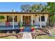 Inviting front porch featuring potted plants and a stone pathway leading to the detailed front door at 201 Gornto Lake Rd, Brandon, FL 33510