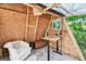 Cozy interior view of outbuilding, featuring wood walls, hardwood floor, comfortable seating, desk and natural light at 201 Gornto Lake Rd, Brandon, FL 33510