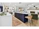 Well-lit kitchen featuring a large center island, white countertops, and a view of the living area fireplace at 201 Gornto Lake Rd, Brandon, FL 33510