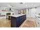 Modern kitchen features a large island with barstools and ample counter space, fireplace, and barn door at 201 Gornto Lake Rd, Brandon, FL 33510